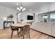 Cozy living room with natural light, stylish dining table, and seamless flow to the outdoor patio at 3086 Kestrel St, Brighton, CO 80601