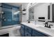 Modern bathroom with blue tile and double vanity at 4942 S Zephyr St, Littleton, CO 80123