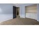 Bedroom with built-in shelving and access to hall at 4942 S Zephyr St, Littleton, CO 80123