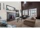 Living room with high ceilings, fireplace, and large windows at 4942 S Zephyr St, Littleton, CO 80123