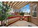 Covered back porch featuring a red fence and a lovely courtyard view at 12610 E Wesley Pl, Aurora, CO 80014