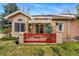 Cozy back porch with awning, red fence, and outdoor sitting area at 12610 E Wesley Pl, Aurora, CO 80014