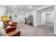 Spacious basement featuring neutral carpet, a bathroom entrance, and comfortable chairs at 12610 E Wesley Pl, Aurora, CO 80014