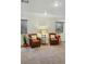Finished basement area featuring two leather chairs, neutral carpet, and natural light at 12610 E Wesley Pl, Aurora, CO 80014