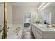 Bathroom with a bathtub and double vanity featuring sleek lighting fixtures at 12610 E Wesley Pl, Aurora, CO 80014