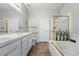 Bathroom with double sinks, tile floors, and a shower with gold trim at 12610 E Wesley Pl, Aurora, CO 80014