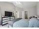 Bright bedroom featuring a ceiling fan, TV and large dresser at 12610 E Wesley Pl, Aurora, CO 80014