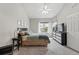 Bright bedroom featuring large windows, neutral decor, and comfortable furnishings at 12610 E Wesley Pl, Aurora, CO 80014