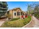 Exterior shot of a single-story home featuring manicured landscaping and a sidewalk at 12610 E Wesley Pl, Aurora, CO 80014