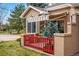 Charming covered side porch featuring an awning and a small red fence at 12610 E Wesley Pl, Aurora, CO 80014