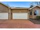 Attached two car garage with brick driveway and exterior lights at 12610 E Wesley Pl, Aurora, CO 80014