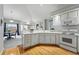 Bright kitchen with white cabinetry and a seamless flow to the dining area at 12610 E Wesley Pl, Aurora, CO 80014