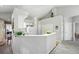 Open kitchen with white cabinets, breakfast bar, and access to the dining area at 12610 E Wesley Pl, Aurora, CO 80014