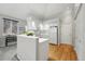 Open-concept kitchen with white cabinetry, vaulted ceilings, and modern appliances at 12610 E Wesley Pl, Aurora, CO 80014