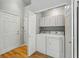 Functional laundry room with washer, dryer, and storage cabinets for organization at 12610 E Wesley Pl, Aurora, CO 80014
