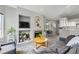 Open-concept living room featuring a fireplace and easy access to the kitchen at 12610 E Wesley Pl, Aurora, CO 80014