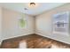 Cozy bedroom features hardwood floors and two bright windows at 14183 Madison Way, Thornton, CO 80602
