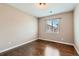 Bright bedroom with hardwood floors and a view from the large window at 14183 Madison Way, Thornton, CO 80602