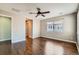 Spacious bedroom with hardwood floors, a ceiling fan, and ample natural light from a large window at 14183 Madison Way, Thornton, CO 80602