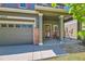 Welcoming front porch with brick accents, swing, and an ADT security system for a secure and inviting entrance at 14183 Madison Way, Thornton, CO 80602