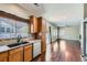 Bright kitchen featuring wood cabinets, stainless steel appliances and an open layout to the living area at 14183 Madison Way, Thornton, CO 80602