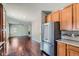 Bright kitchen with stainless steel appliances and hardwood floors adjacent to a living space at 14183 Madison Way, Thornton, CO 80602