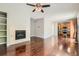 Inviting living room featuring a fireplace, hardwood floors, and seamless transition to the kitchen at 14183 Madison Way, Thornton, CO 80602