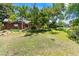 Expansive, shady backyard featuring a brick ranch home with a large lawn and play structure at 1475 Kingsbury Ct, Golden, CO 80401