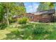 Backyard featuring a patio with a pergola, lush greenery, and a well-maintained lawn at 1475 Kingsbury Ct, Golden, CO 80401