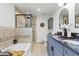 Elegant bathroom featuring double vanity, soaking tub, a tiled walk-in shower, and modern fixtures at 1475 Kingsbury Ct, Golden, CO 80401