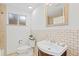 Bright bathroom featuring a modern vanity, tiled floor, and a large mirror at 1475 Kingsbury Ct, Golden, CO 80401