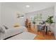 Well-lit bedroom with a twin bed, desk, and a large window at 1475 Kingsbury Ct, Golden, CO 80401