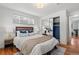 Bright bedroom with hardwood floors, closet with mirrored doors, and a large window providing natural light at 1475 Kingsbury Ct, Golden, CO 80401