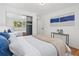 Bright bedroom featuring a large window with views and a modern accent wall art at 1475 Kingsbury Ct, Golden, CO 80401