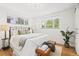 Bright bedroom with large windows, hardwood floors, and a comfortable seating area at 1475 Kingsbury Ct, Golden, CO 80401