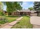 Charming brick home with a well-manicured front lawn and inviting walkway at 1475 Kingsbury Ct, Golden, CO 80401