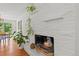 Modern painted brick fireplace with decor, complemented by hardwood floors and natural light at 1475 Kingsbury Ct, Golden, CO 80401