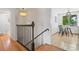 Hallway featuring hardwood floors, iron railing and a charming chandelier at 1475 Kingsbury Ct, Golden, CO 80401