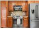 Kitchen with stainless steel appliances, including oven, microwave, and refrigerator, complemented by wooden cabinets at 1475 Kingsbury Ct, Golden, CO 80401