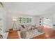 Spacious living room boasts hardwood floors, white walls, a large window and stylish decor at 1475 Kingsbury Ct, Golden, CO 80401