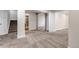 Spacious finished basement with neutral carpet, stairs, and open doorway to a bedroom at 19551 E Mann Creek Dr # B, Parker, CO 80134