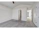 Carpeted bedroom showcasing multiple entryways and neutral paint scheme at 19551 E Mann Creek Dr # B, Parker, CO 80134
