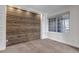 Bedroom featuring unique wood paneled wall and window with natural light at 19551 E Mann Creek Dr # B, Parker, CO 80134