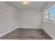 Light-filled bedroom boasts wood floors, neutral walls, and a window offering neighborhood views at 19551 E Mann Creek Dr # B, Parker, CO 80134
