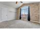 Spacious bedroom with an arched window and stone accent wall at 19551 E Mann Creek Dr # B, Parker, CO 80134