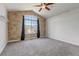Bedroom with vaulted ceiling, arched window, and stone accent wall at 19551 E Mann Creek Dr # B, Parker, CO 80134