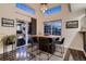 Modern dining area with a stylish table, contemporary lighting, and deck access at 19551 E Mann Creek Dr # B, Parker, CO 80134