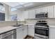 Bright kitchen with stainless steel appliances, light countertops, and lots of natural light at 19551 E Mann Creek Dr # B, Parker, CO 80134