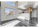 Open concept living room with clerestory windows, hardwood floors, and view of the kitchen at 19551 E Mann Creek Dr # B, Parker, CO 80134