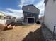 A fenced backyard featuring a patio, balcony, and a garden bed offers outdoor living at 5295 Andes St, Denver, CO 80249